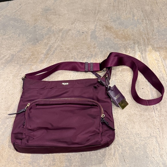 Tumi Handbags - TUMI
Voyageur Capri Crossbody plum purple color in GUC